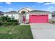 Charming single-Gathering home showcasing a well-manicured lawn and inviting red garage door at 2535 Oneida Loop, Kissimmee, FL 34747