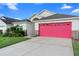 Charming single-Gathering home showcasing a well-manicured lawn and inviting red garage door at 2535 Oneida Loop, Kissimmee, FL 34747