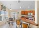 Eat-in kitchen with breakfast bar, oak cabinetry, tile floors, and a window overlooking the backyard at 2535 Oneida Loop, Kissimmee, FL 34747