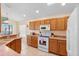 Kitchen with oak cabinets, tile floors, solid surface countertops, and breakfast bar at 2535 Oneida Loop, Kissimmee, FL 34747