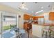 Eat-in kitchen features wooden cabinets, stainless appliances, and a breakfast nook at 2535 Oneida Loop, Kissimmee, FL 34747