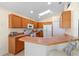 Bright kitchen with oak cabinets, breakfast bar, and skylight offering plenty of natural light at 2535 Oneida Loop, Kissimmee, FL 34747