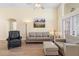 Bright living room with wood floors, comfortable seating, and large windows allowing ample sunlight at 2535 Oneida Loop, Kissimmee, FL 34747