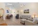 Open-concept living area with dining table, wood floors, and comfortable seating arrangement at 2535 Oneida Loop, Kissimmee, FL 34747