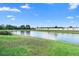 Scenic view of a serene pond with lush green landscaping, creating a peaceful backyard ambiance at 2535 Oneida Loop, Kissimmee, FL 34747