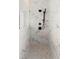 Marble tiled shower with black shower fixture and a tiled floor at 2535 Oneida Loop, Kissimmee, FL 34747
