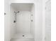 Clean bathroom with tiled shower, white subway tiles, and built-in shelving at 2601 Spring Hill Dr, Kissimmee, FL 34743