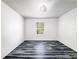Clean bedroom with stylish floors, neutral walls, and a window offering natural light at 2601 Spring Hill Dr, Kissimmee, FL 34743