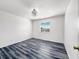 This bedroom features hardwood floors, a window, and neutral walls at 2601 Spring Hill Dr, Kissimmee, FL 34743