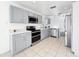 Modern kitchen with stainless steel appliances, gray cabinetry, and quartz countertops at 2601 Spring Hill Dr, Kissimmee, FL 34743