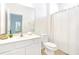 Bright bathroom with a white vanity, modern fixtures and light tile flooring at 2618 Calistoga Ave, Kissimmee, FL 34741