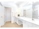 Bright bathroom with double vanity, large mirror, and tile floors, offering a clean and modern space at 2618 Calistoga Ave, Kissimmee, FL 34741