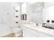 Bright bathroom featuring a white vanity, and a decorative mirror with modern fixtures at 2618 Calistoga Ave, Kissimmee, FL 34741