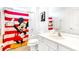 Cheerful bathroom featuring white cabinets, a shower, and a Mickey Mouse-themed shower curtain at 2618 Calistoga Ave, Kissimmee, FL 34741