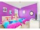 Charming bedroom featuring twin beds, purple walls, and 'Frozen' themed decor at 2618 Calistoga Ave, Kissimmee, FL 34741