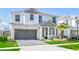 Beautiful two-story home with a gray driveway, two-car garage, manicured lawn, and tropical landscaping at 2618 Calistoga Ave, Kissimmee, FL 34741