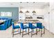 A modern kitchen featuring white cabinets, an island with bar stool seating, and black countertops at 2618 Calistoga Ave, Kissimmee, FL 34741