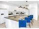 A modern kitchen featuring white cabinets, a black granite countertop island with seating for four at 2618 Calistoga Ave, Kissimmee, FL 34741