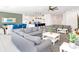 A bright and airy living room and dining room are with comfortable gray sofas and modern decor at 2618 Calistoga Ave, Kissimmee, FL 34741