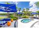 Outdoor lounge area with cozy seating, blue umbrellas, and a relaxing spa pool at 2618 Calistoga Ave, Kissimmee, FL 34741