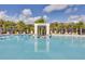 Resort-style pool surrounded by palm trees and lounge chairs, perfect for relaxation at 2618 Calistoga Ave, Kissimmee, FL 34741