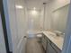 Bathroom features a shower-tub combo and vanity with white countertop at 2963 Embark Trail, St Cloud, FL 34771