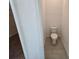 Small bathroom features a standard toilet and neutral tile flooring at 2963 Embark Trail, St Cloud, FL 34771