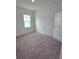 Bedroom with plush carpet, double-hung window, and white door at 2963 Embark Trail, St Cloud, FL 34771