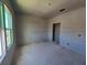 A bedroom with a window and a door is ready to be finished at 2963 Embark Trail, St Cloud, FL 34771