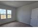 Bedroom with two windows overlooking the yard and carpet floors at 2963 Embark Trail, St Cloud, FL 34771
