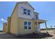 Newly constructed home with yellow siding and a covered front porch at 2963 Embark Trail, St Cloud, FL 34771