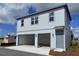 Modern two-story home with a two-car garage and gray siding on a sunny day at 2963 Embark Trail, St Cloud, FL 34771