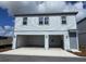 A modern two-story home featuring a two-car garage and gray siding under a bright blue sky at 2963 Embark Trail, St Cloud, FL 34771