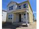 Construction of a two-story home with a covered porch and multiple windows at 2963 Embark Trail, St Cloud, FL 34771
