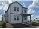Well-designed two-story home featuring a cozy front porch and multiple windows at 2963 Embark Trail, St Cloud, FL 34771