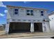 Spacious two-car garage awaiting customization in a new home construction project at 2963 Embark Trail, St Cloud, FL 34771