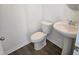 Powder room features pedestal sink, modern fixtures, and wood-look flooring at 2963 Embark Trail, St Cloud, FL 34771