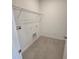 Laundry room with tile flooring, washer-dryer hookups, and overhead wire rack at 2963 Embark Trail, St Cloud, FL 34771