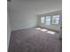 Spacious living room featuring large windows and plush carpet floors at 2963 Embark Trail, St Cloud, FL 34771