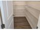Walk-in pantry features wood-look flooring and multiple wire shelves for optimal storage at 2963 Embark Trail, St Cloud, FL 34771
