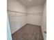 Empty walk-in closet with wire shelving and neutral carpeting at 2963 Embark Trail, St Cloud, FL 34771