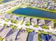 Community aerial showcases homes nestled around a tranquil lake and accessible roads for easy navigation at 3041 Cardillino Way, Kissimmee, FL 34741