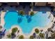 Stunning aerial view of a large community pool with palm trees and ample seating at 3041 Cardillino Way, Kissimmee, FL 34741