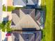 Aerial view of a home featuring a screened-in pool and backyard adjacent to a serene lake at 3041 Cardillino Way, Kissimmee, FL 34741