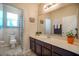Neutral bathroom with a large mirror, dark wood cabinets and a shower/tub combination at 3041 Cardillino Way, Kissimmee, FL 34741
