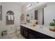Elegant bathroom with a double sink vanity, decorative mirrors, and contemporary fixtures at 3041 Cardillino Way, Kissimmee, FL 34741