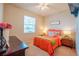 Cozy bedroom with bright bedding, side tables, window, and dresser at 3041 Cardillino Way, Kissimmee, FL 34741