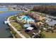 Aerial view of the community pool area featuring a pool, splashpad, and clubhouse surrounded by a picturesque lake at 3041 Cardillino Way, Kissimmee, FL 34741