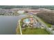 Aerial shot of a community pool area by a lake, featuring multiple pools, seating, and recreational amenities at 3041 Cardillino Way, Kissimmee, FL 34741