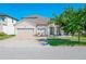 Charming single-Gathering home with a well-manicured lawn and a three-car garage on a sunny day at 3041 Cardillino Way, Kissimmee, FL 34741